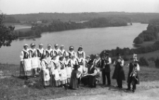 Folk group &lsquo;Modraki&rsquo; from Parchowo in the background of Lake Mausz