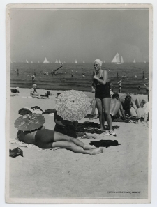 Black and white photograph showing beachgoers