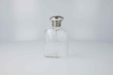 Glass bottle with MG monogram
